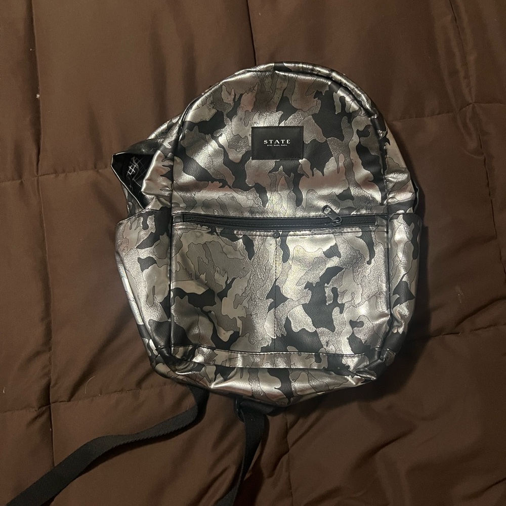 This is a mini camouflage backpack from State and is barely used.